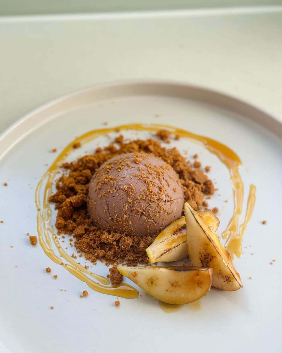 Featured image for “Vegan Cacao Parfait Dome with Lotus Crumb, Brûlée Pear, and Chai Syrup”